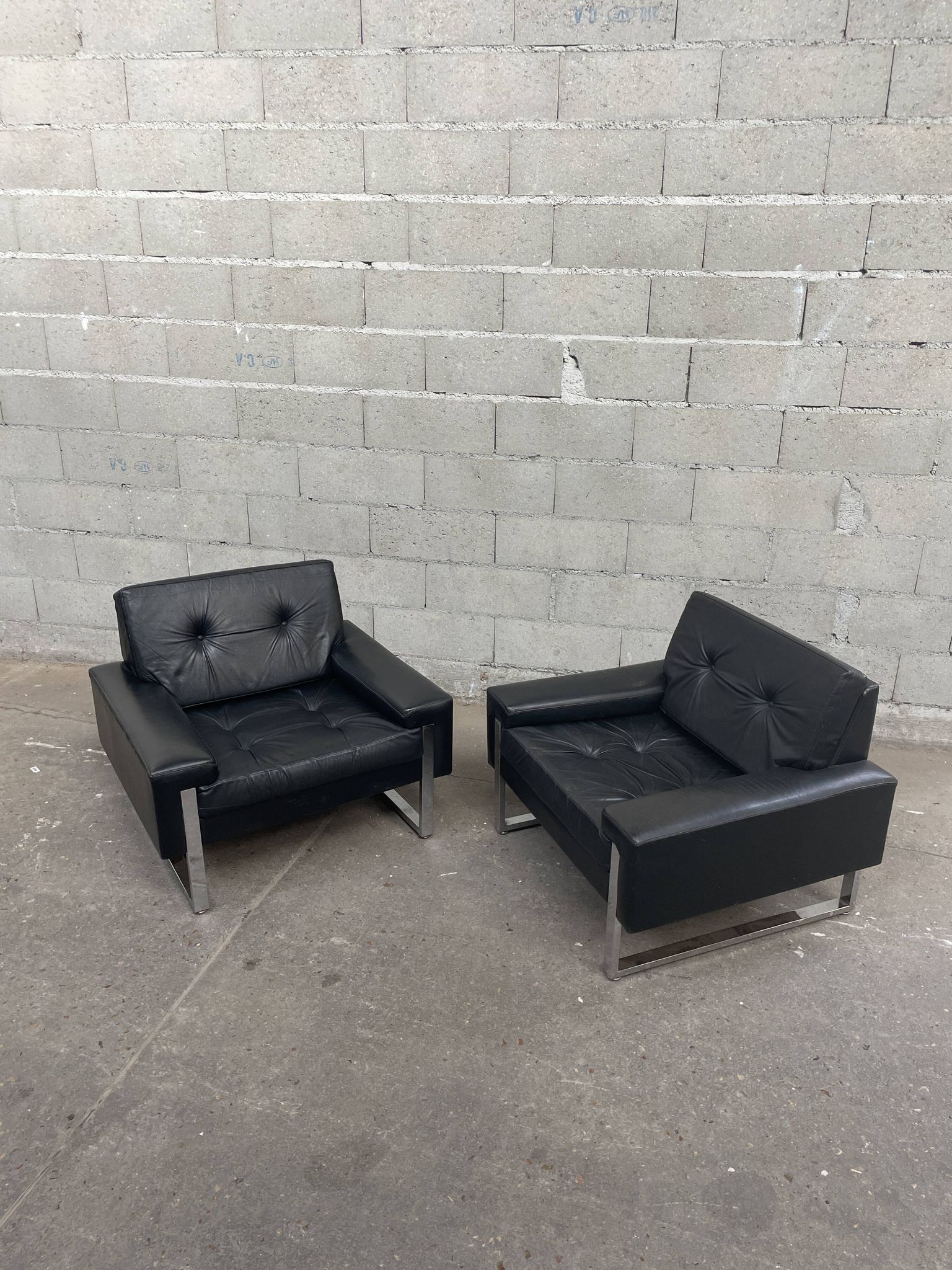 Pair of black leather armchairs