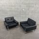 Pair of black leather armchairs
