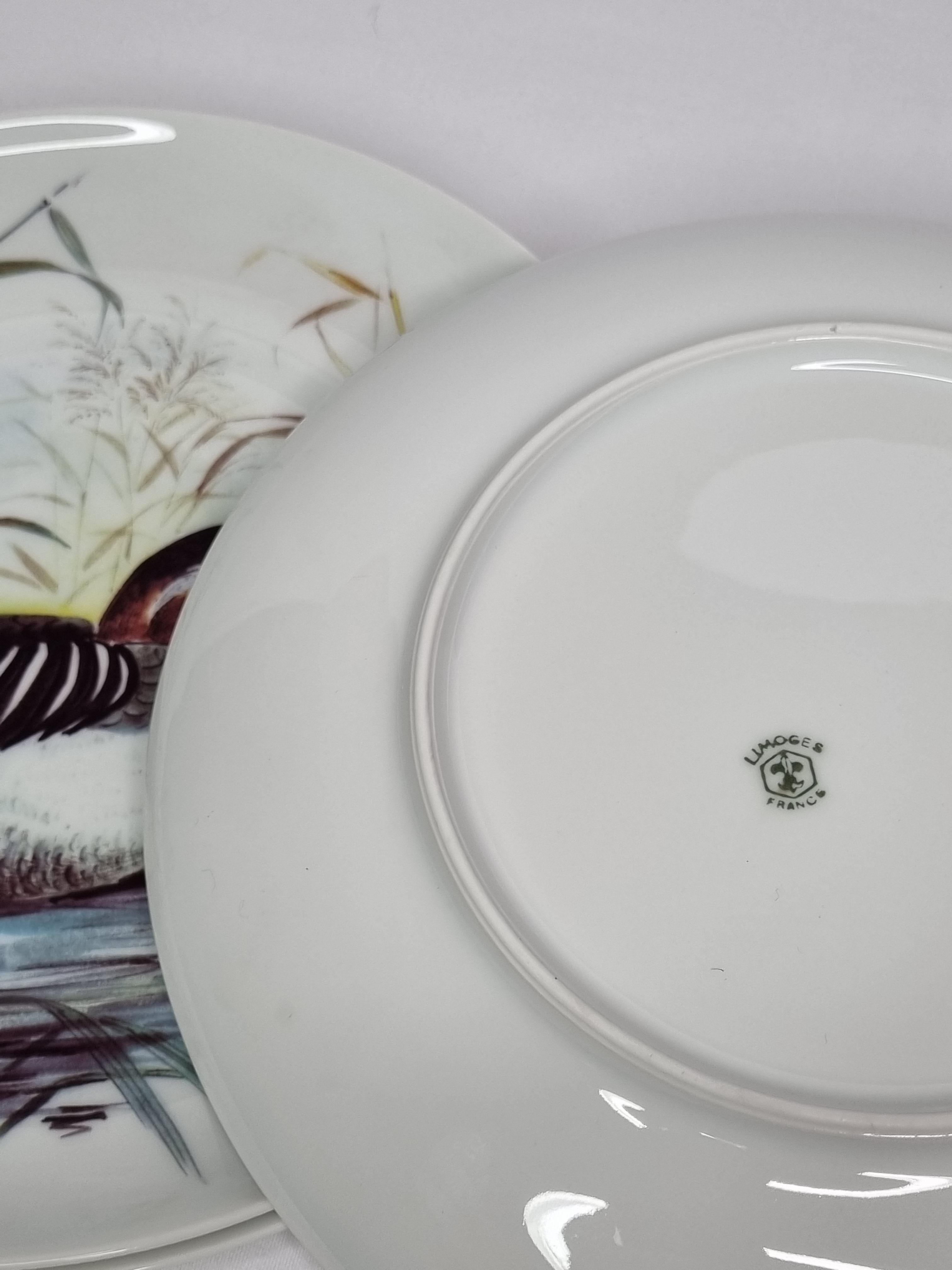 Set of six porcelain plates decorated with birds from Sologne, Limoges, signed, 25 cm