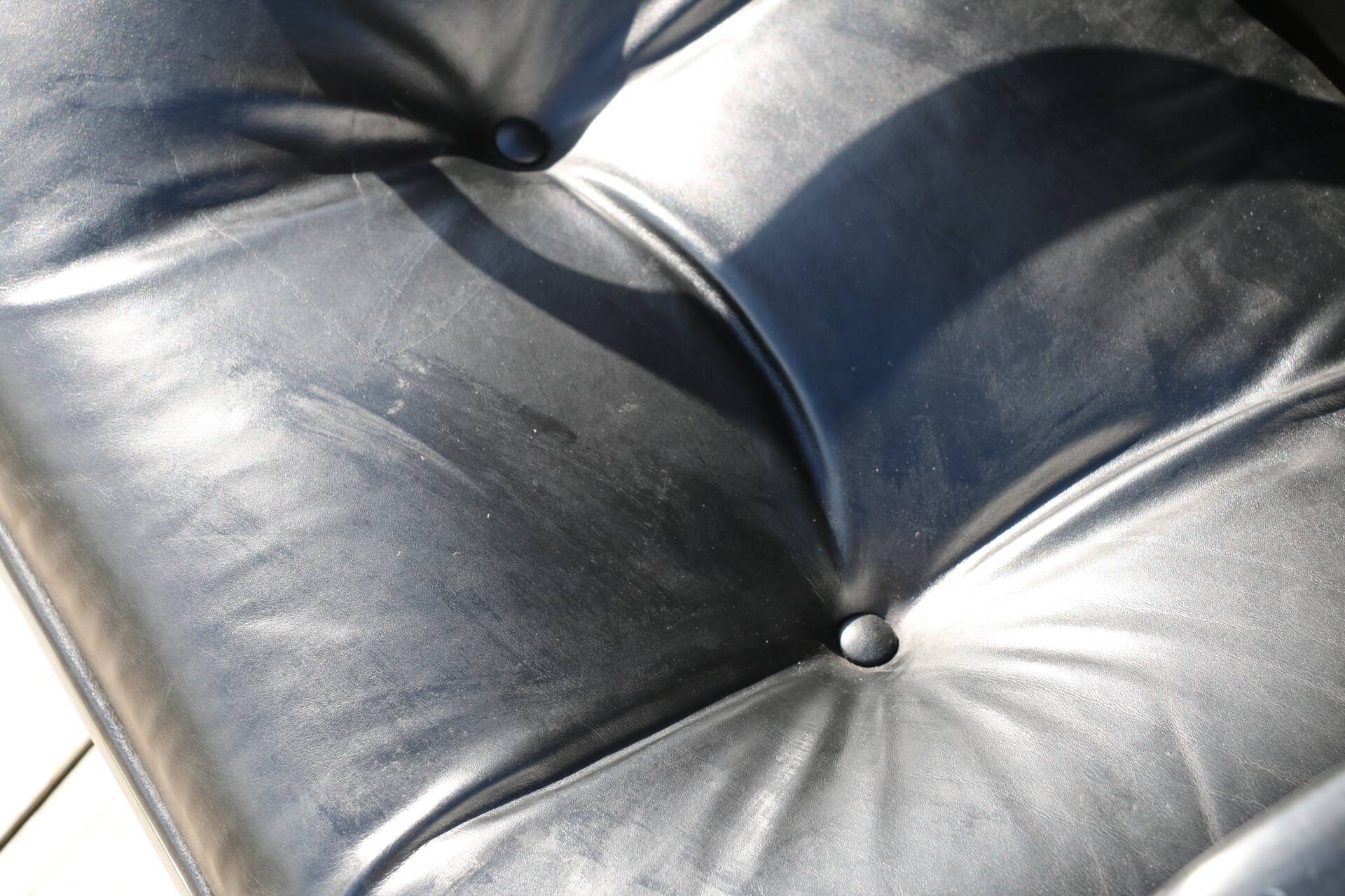 POLLOCK black leather reclining armchair with casters