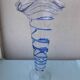 Glass vase on a pedestal with a blue trim.