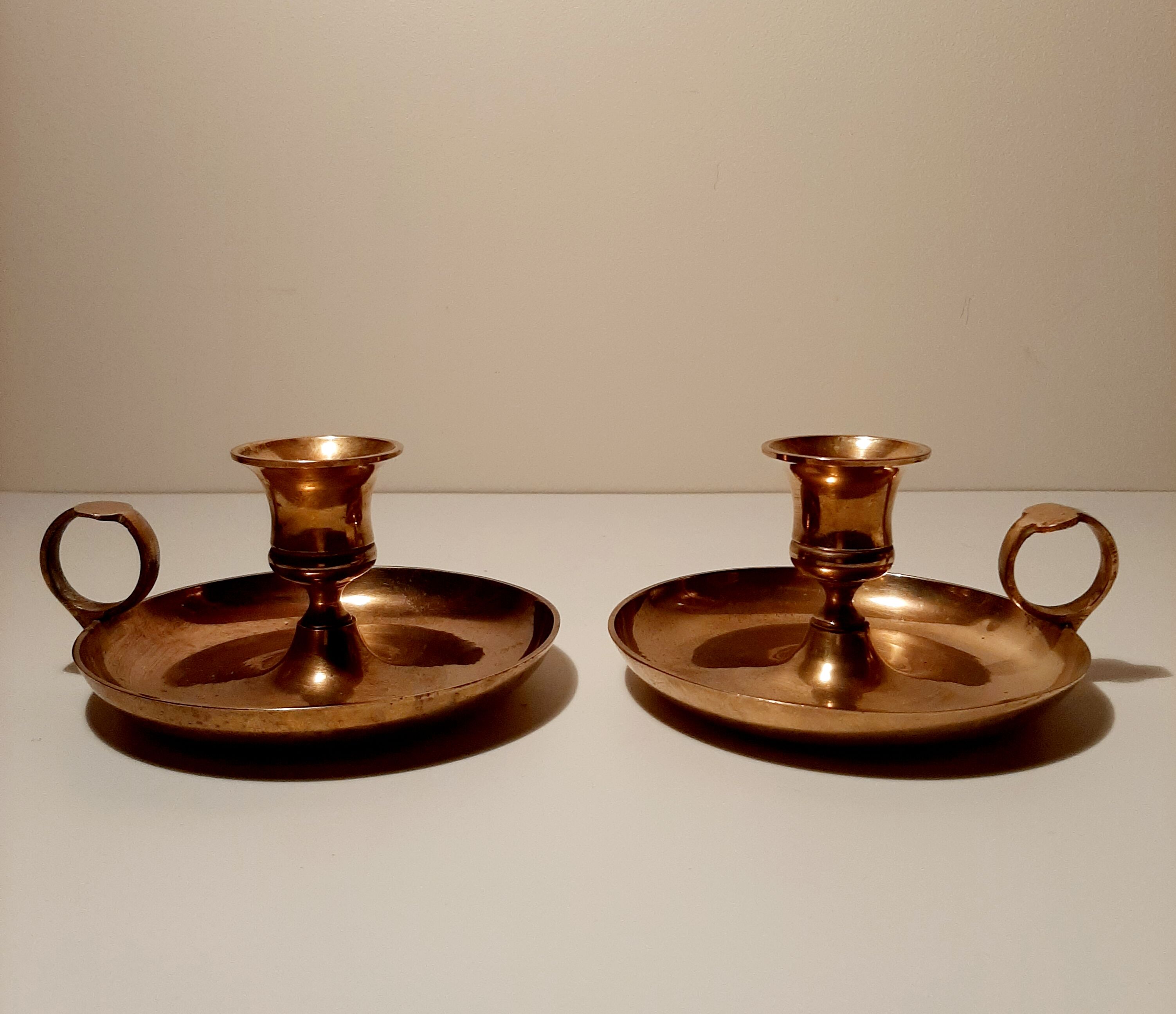 Pair of brass hand candlesticks