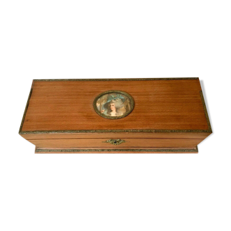 Natural wooden jewelry box decorated with a medallion in a portrait of a woman