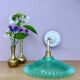 Green vintage plastic wall lamp with a curved arm