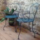 A pair of metal garden chairs