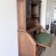 Large secretary with a drop-down front in carved oak, neo-Renaissance style.