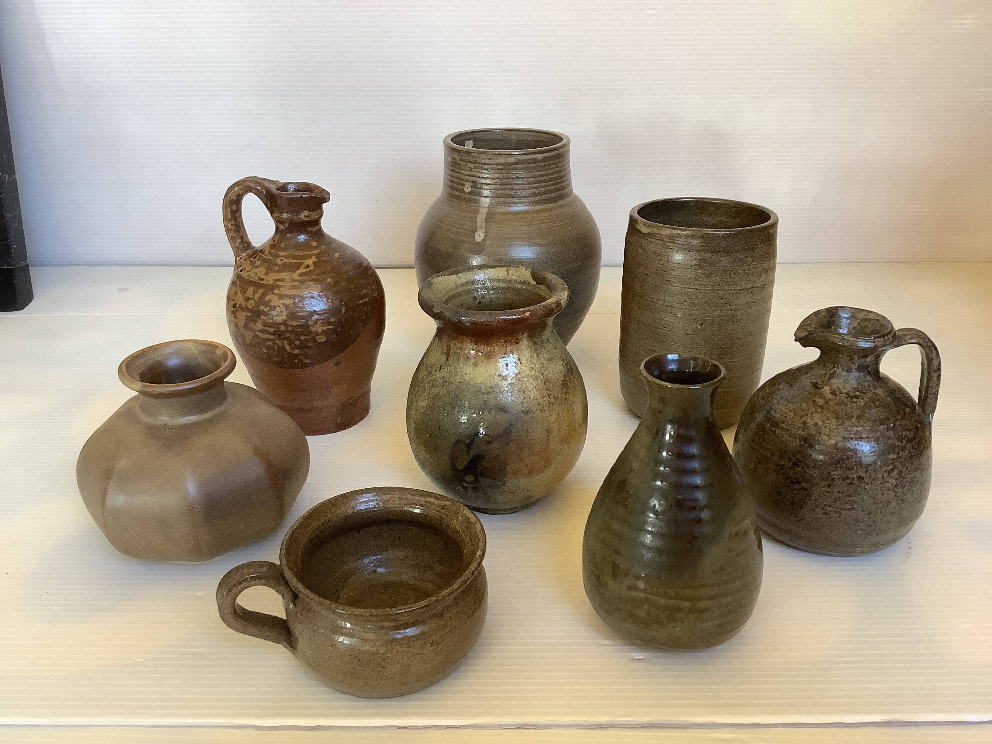 Eight brown ceramic pitcher vases