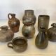 Eight brown ceramic pitcher vases