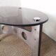 Table basse design vintage en alu brossé et plateau de verre.