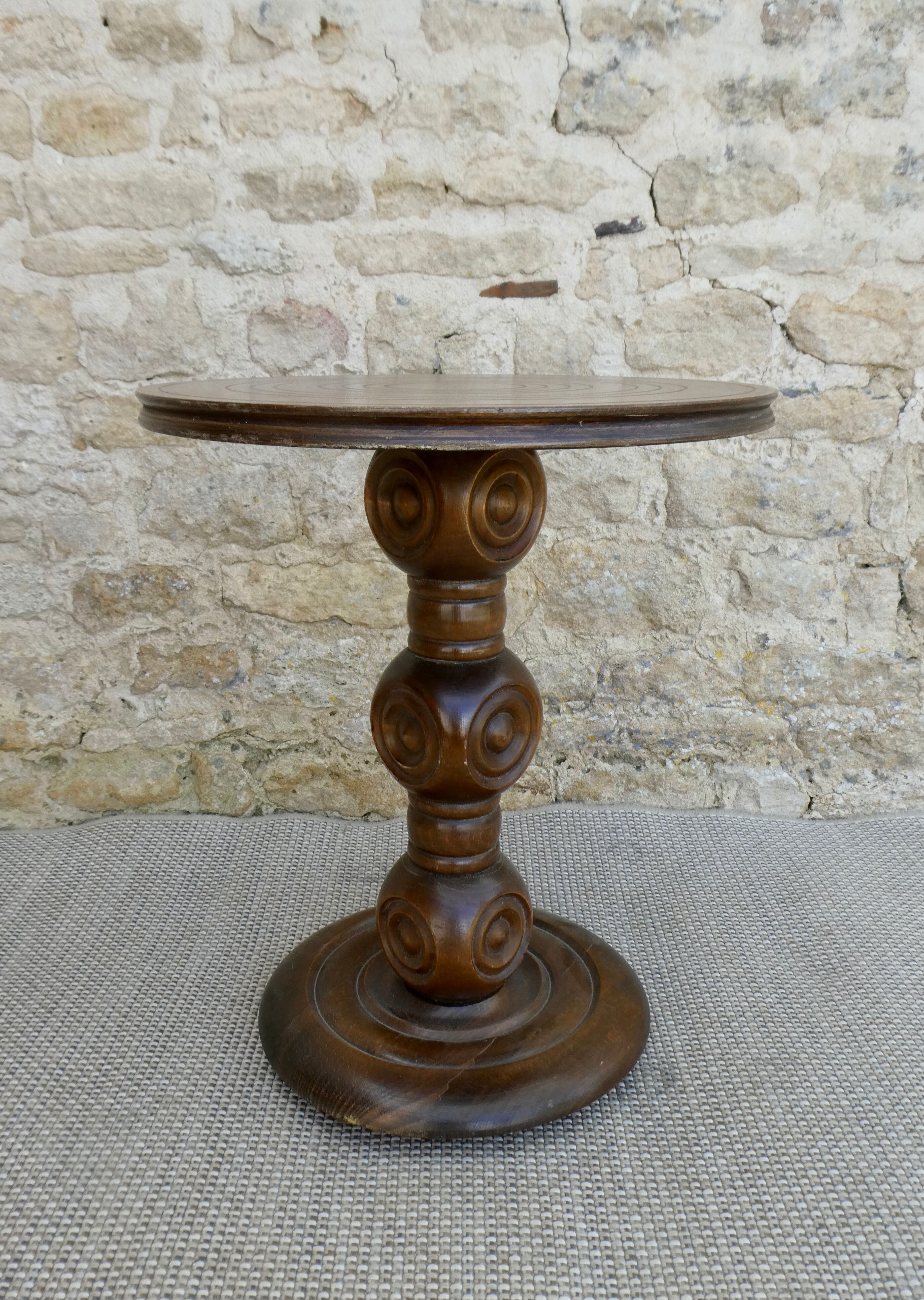 Pedestal table on carved wooden base