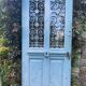 Entrance door in solid oak, cast iron grille, 1930s