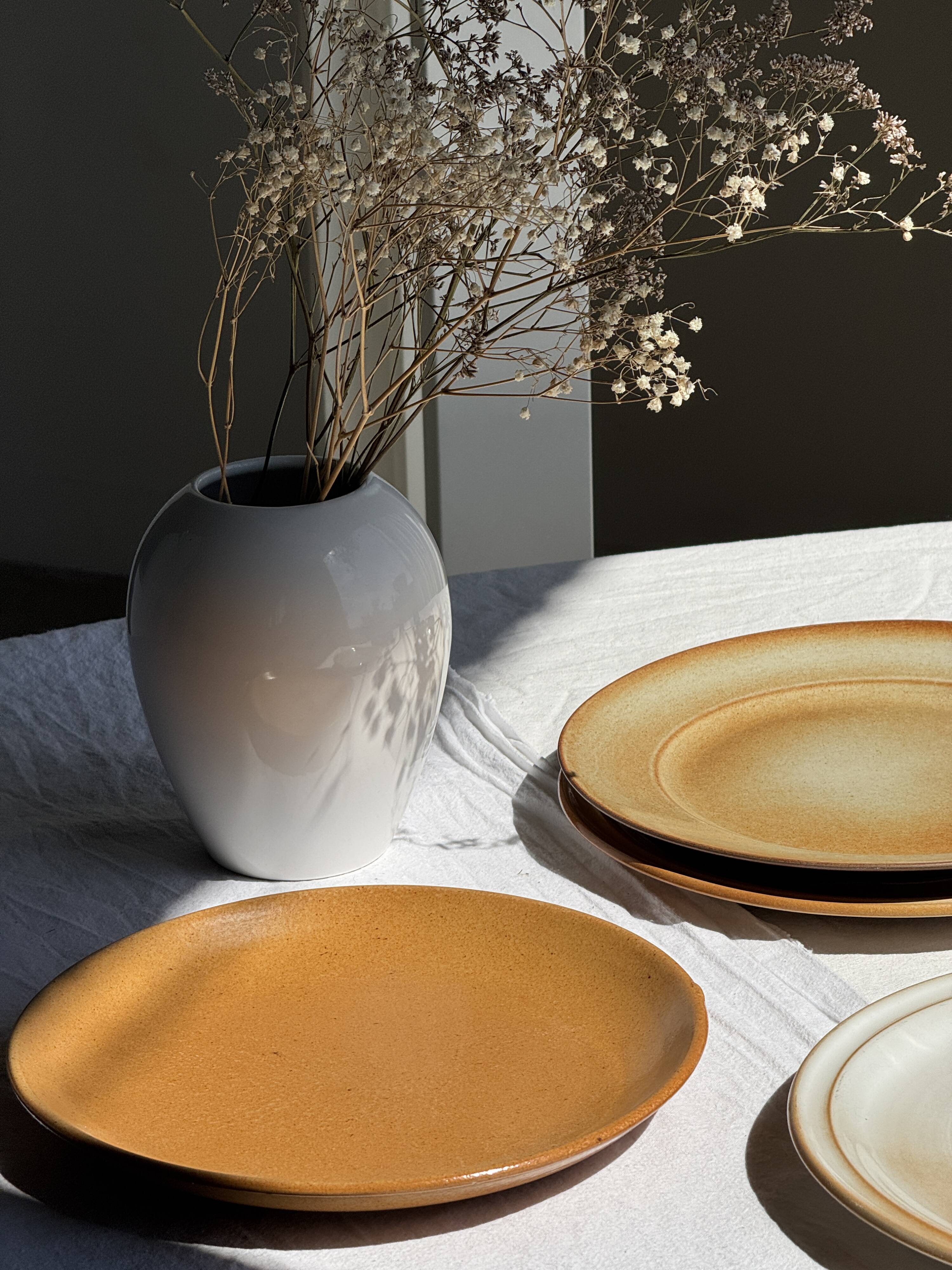 Set of 4 vintage stoneware plates, including 2 with floral motifs