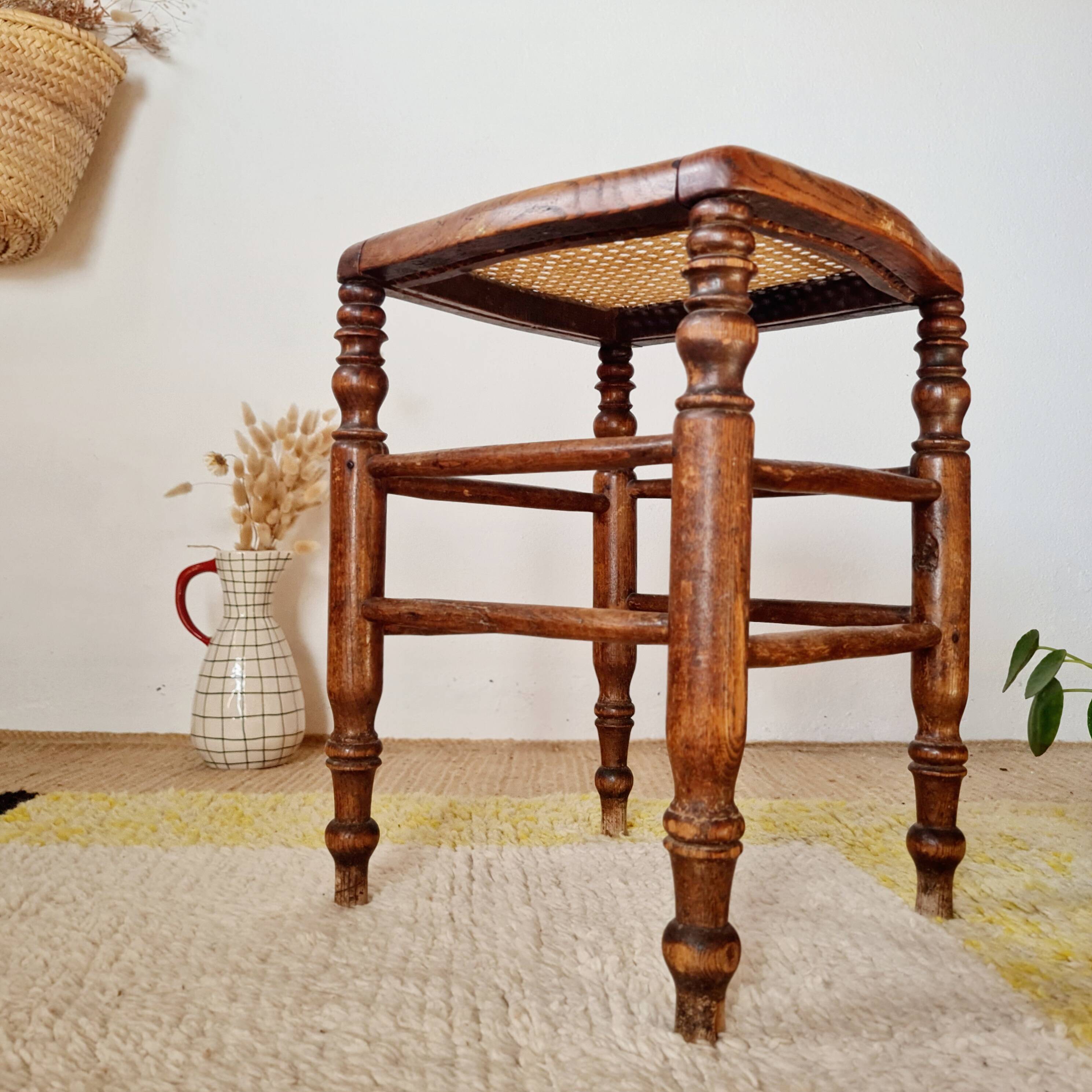 Wooden stool with cane seat