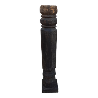Old wooden pillar on pedestal