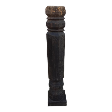 Old wooden pillar on pedestal