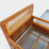 Vintage oak and rattan baby cot from the 1960s.
