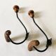 Pair of antique wooden and metal coat hooks