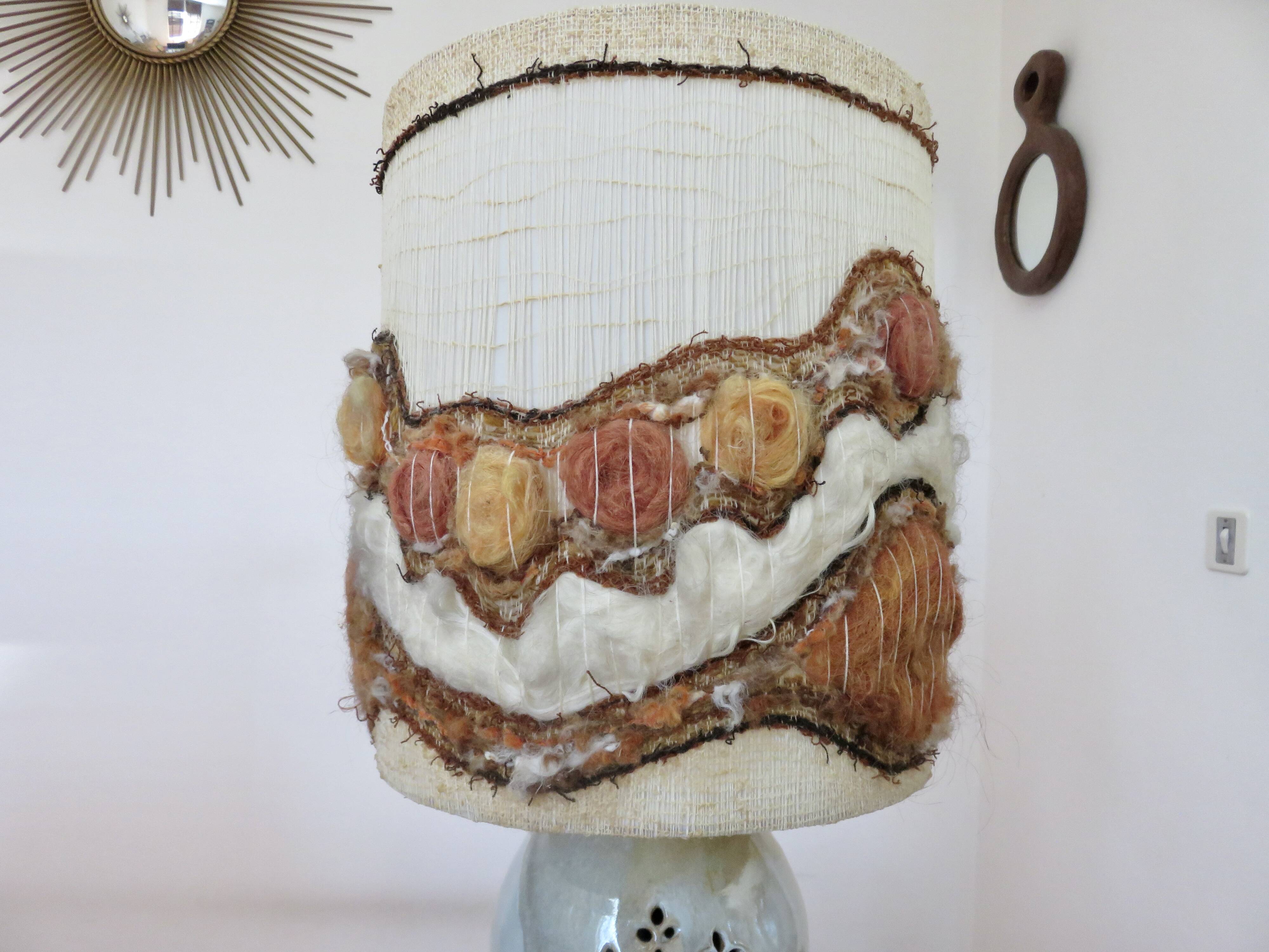 Ceramic lamp with double lighting and openwork design.