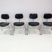 Set of four Egon Eiermann model SE 68 chairs in black lacquered plywood and steel.