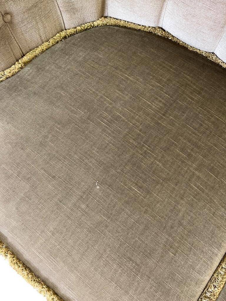 Vintage green two-seater sofa with fringes