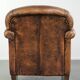 Comfortable characterful sheepskin armchair finished with decorative nails
