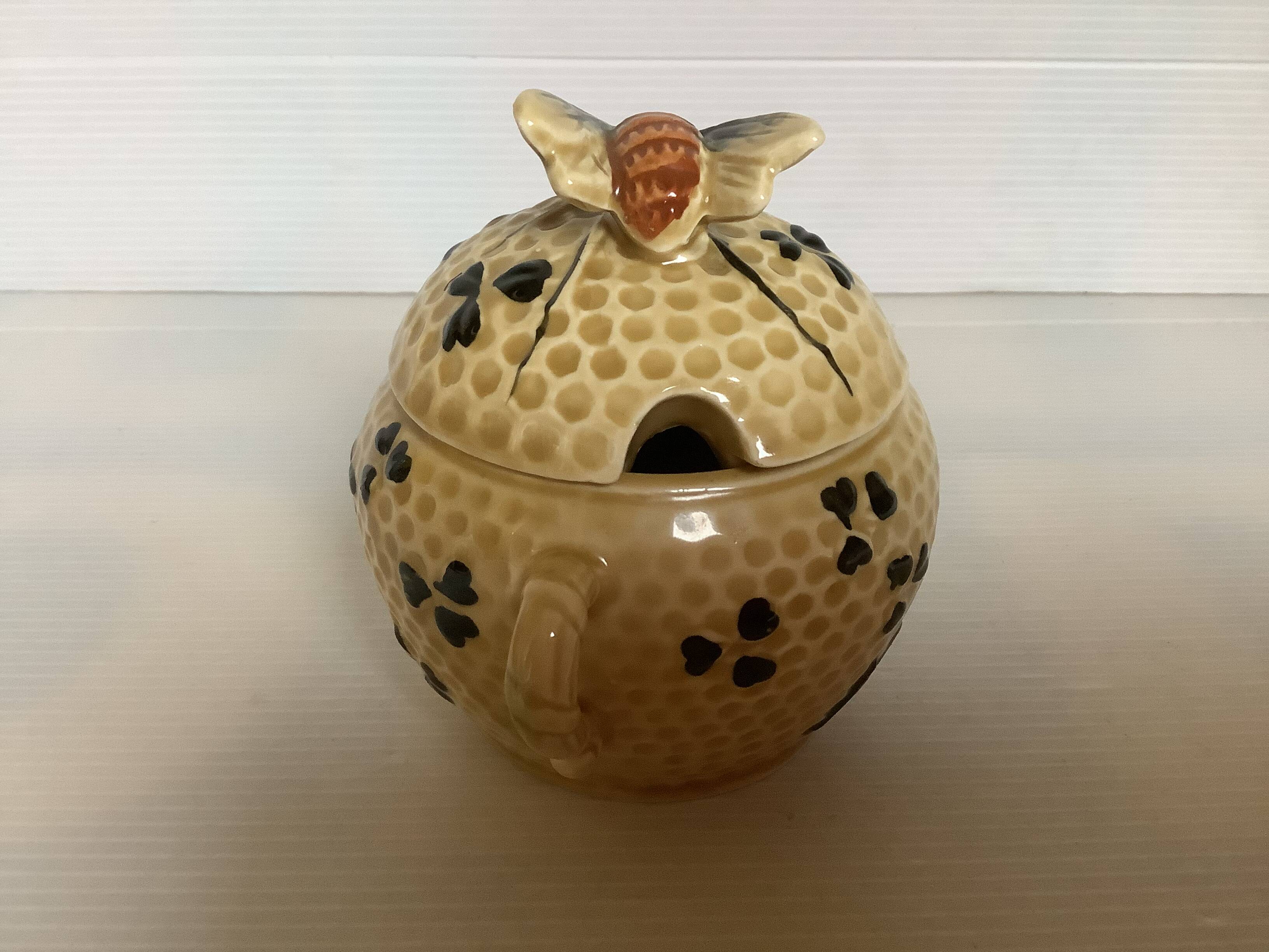 Old honey pot with bee decoration