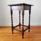 Antique solid oak side table with turned wooden legs.