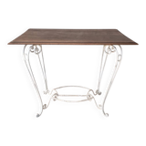 Wrought iron table with a walnut top.