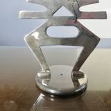 Ethnic “skeleton” candle holder in nickel-plated brass from the 80s