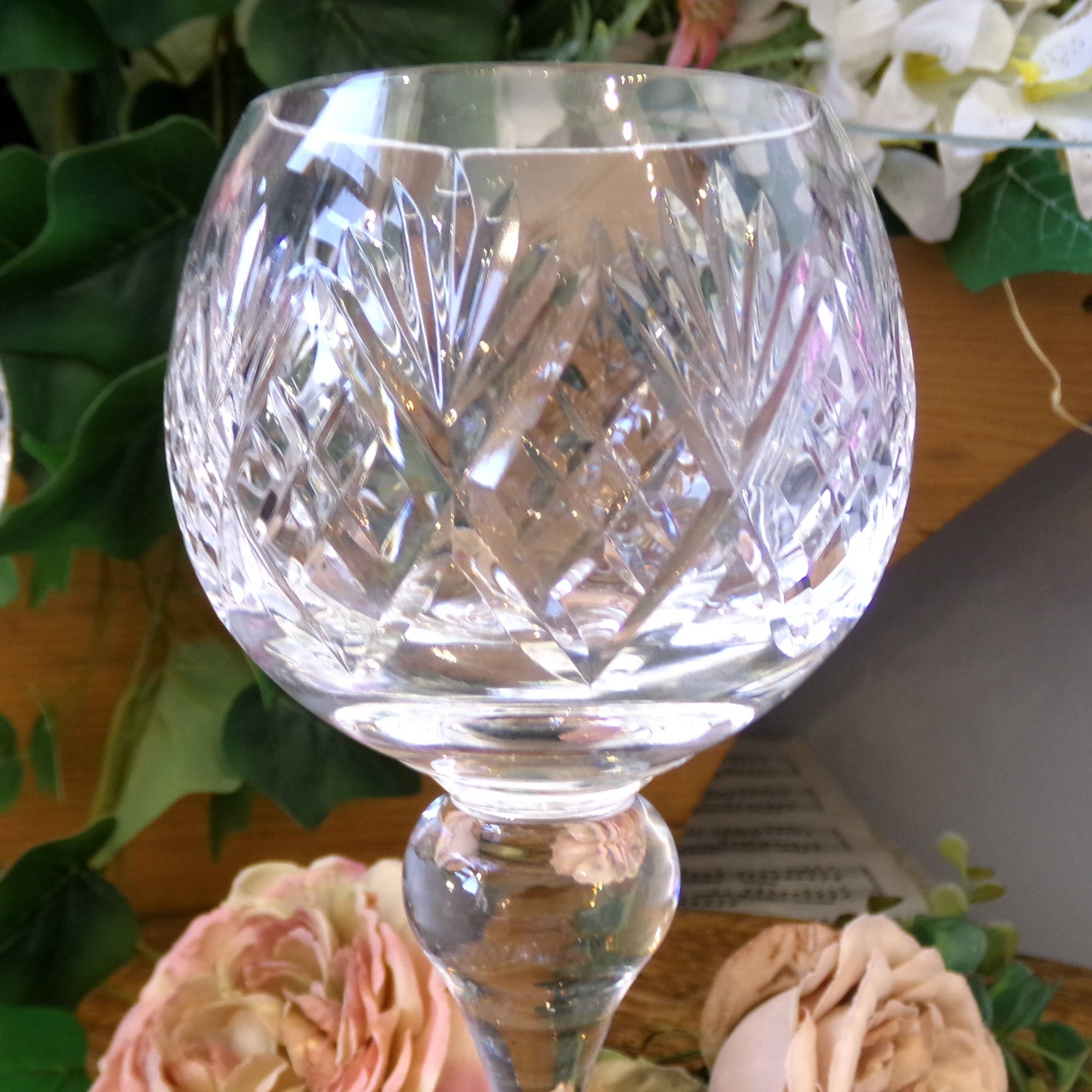 4 lead crystal wine glasses with slender baluster stems.