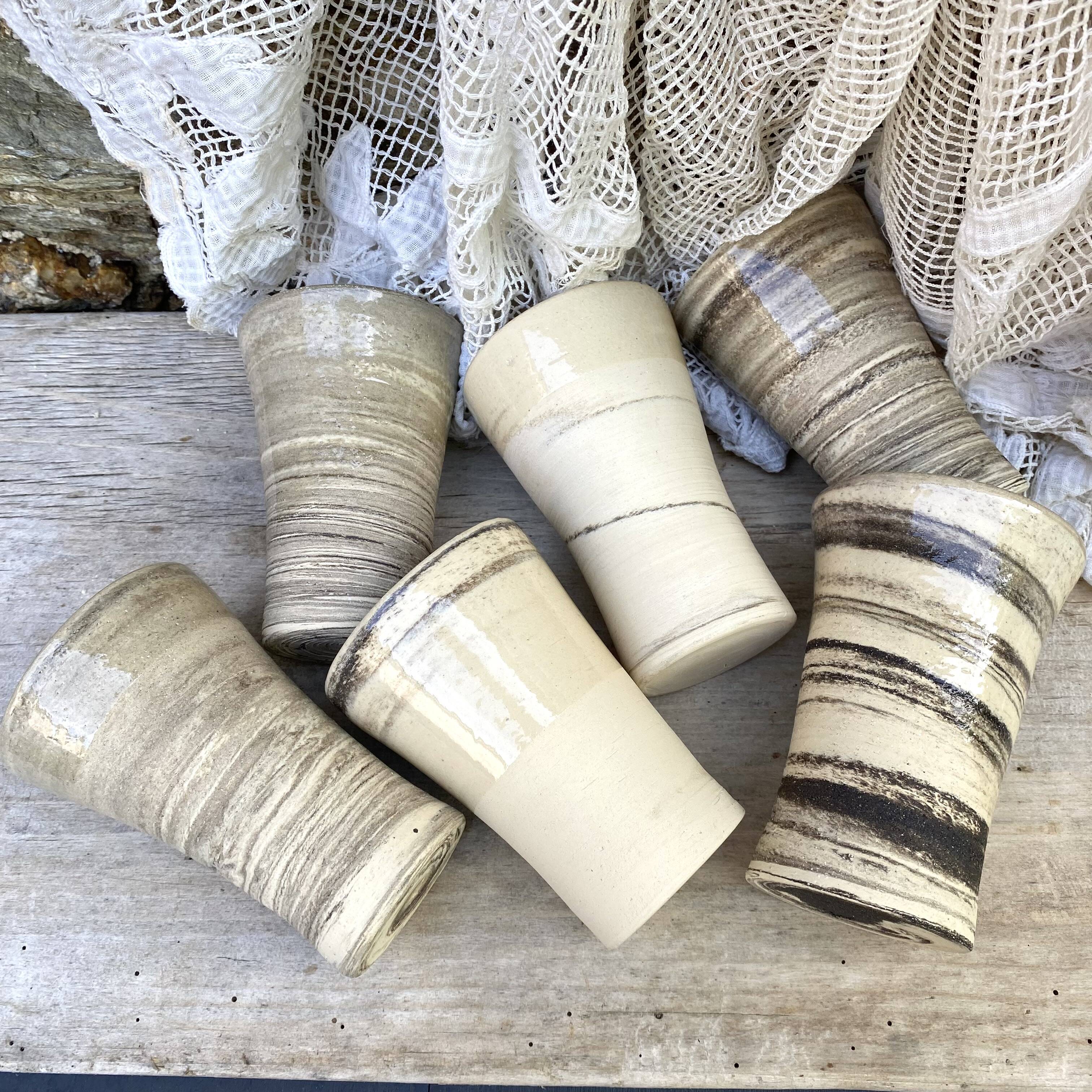 High ceramic cups made of mixed clay.