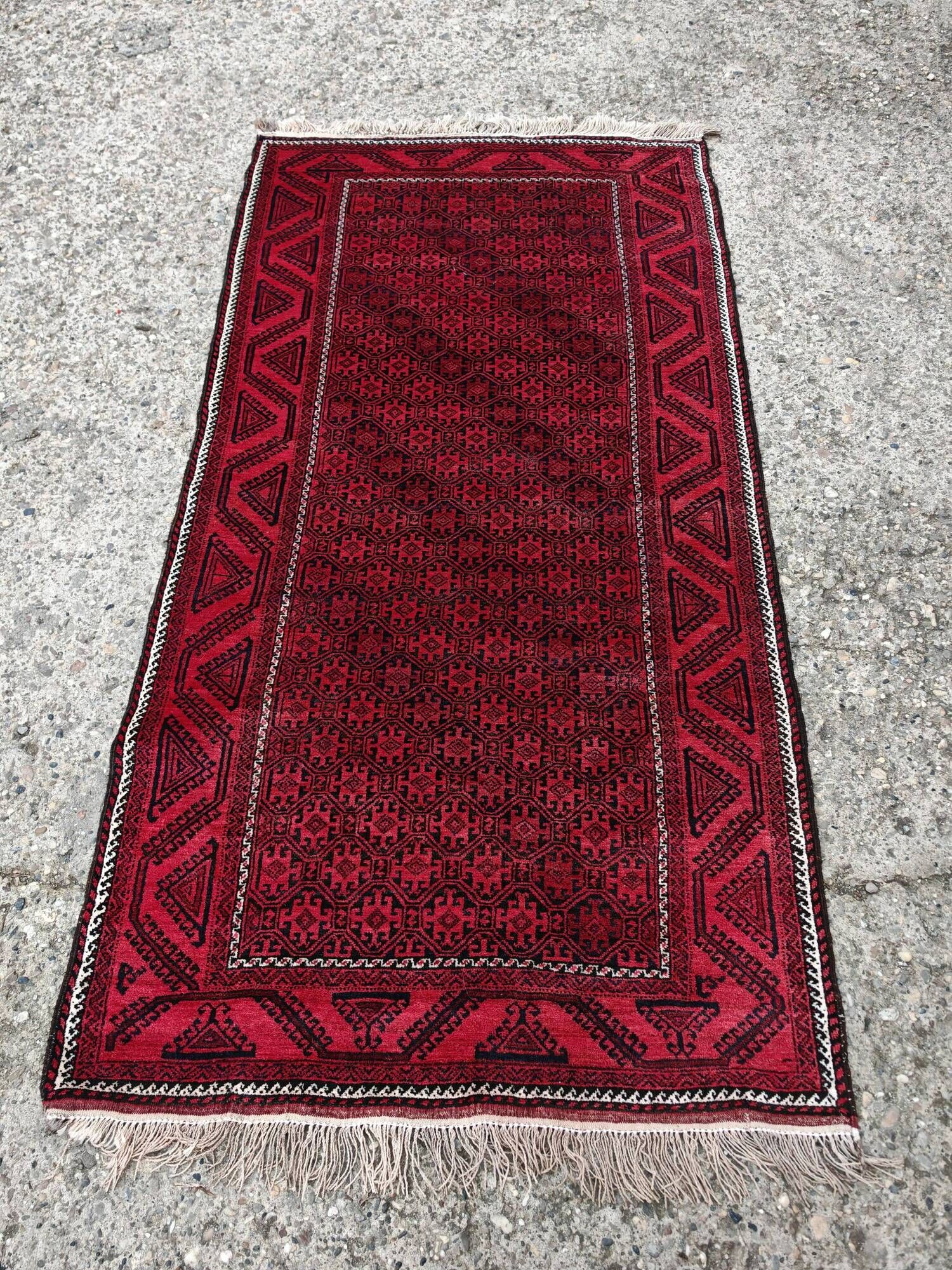 Vintage handmade Baluch rug with geometric pattern from the 1950s.
