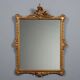 Antique Rococo-style mirror in carved gilded wood, 20th century.