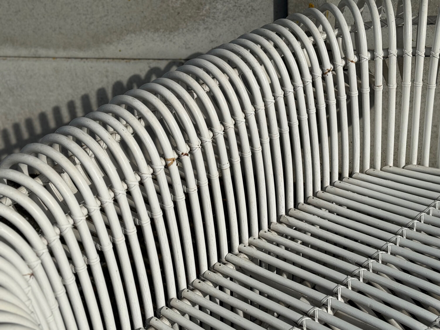Rattan lounge with two two-seater sofas and a white coffee table.
