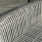Rattan lounge with two two-seater sofas and a white coffee table.