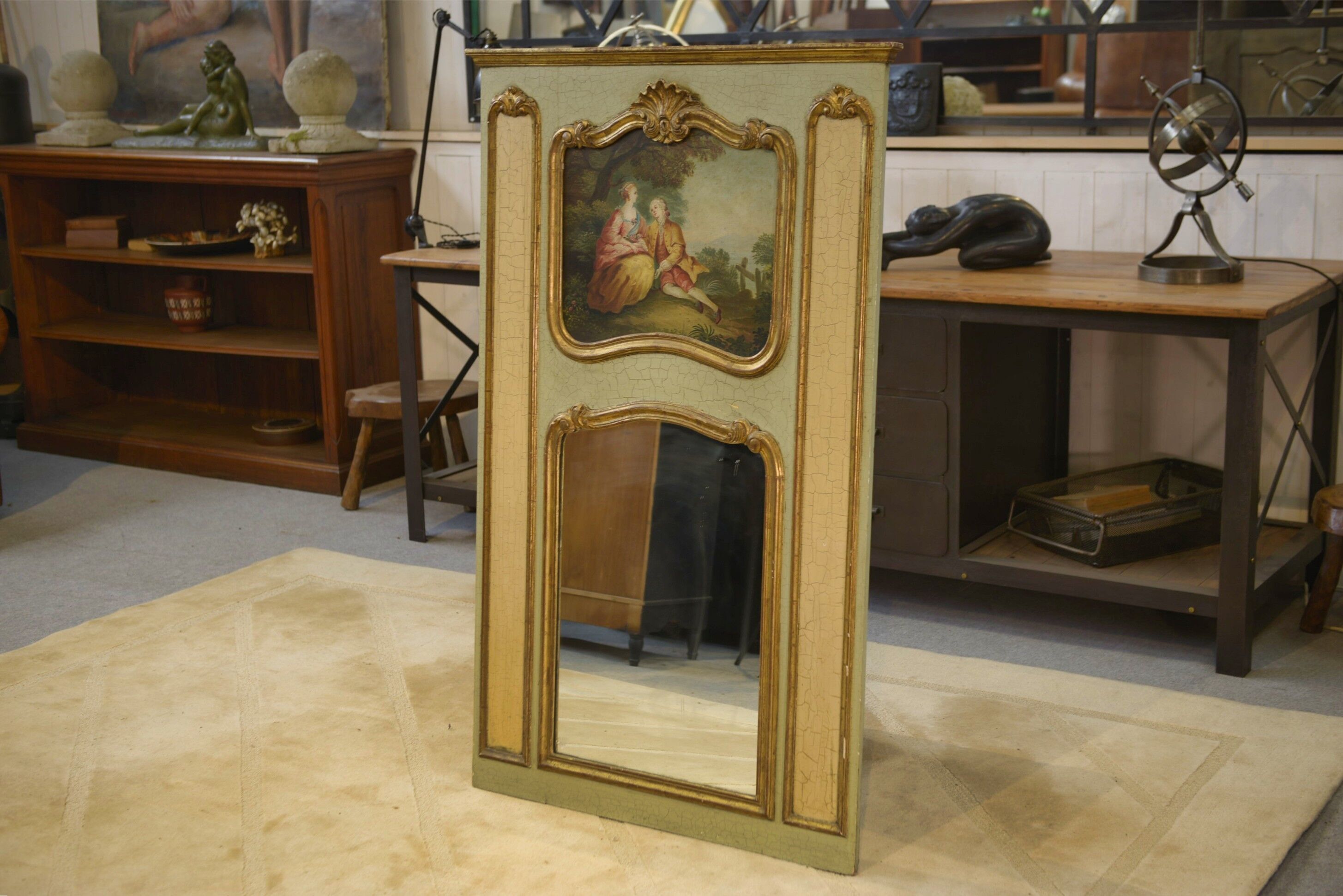 Trumeau mirror with cracked patina and oil on panel depicting a romantic scene from the 19th century.