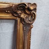Old frame in wood and gilded stucco