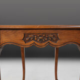 Side table with sculpted elements and rattan top