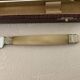 Complete Set of 12 Stainless Steel Cheese Knives with Bakelite Handles and Art Deco Ferrules