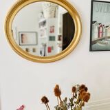 Oval wall mirror in gilded wood