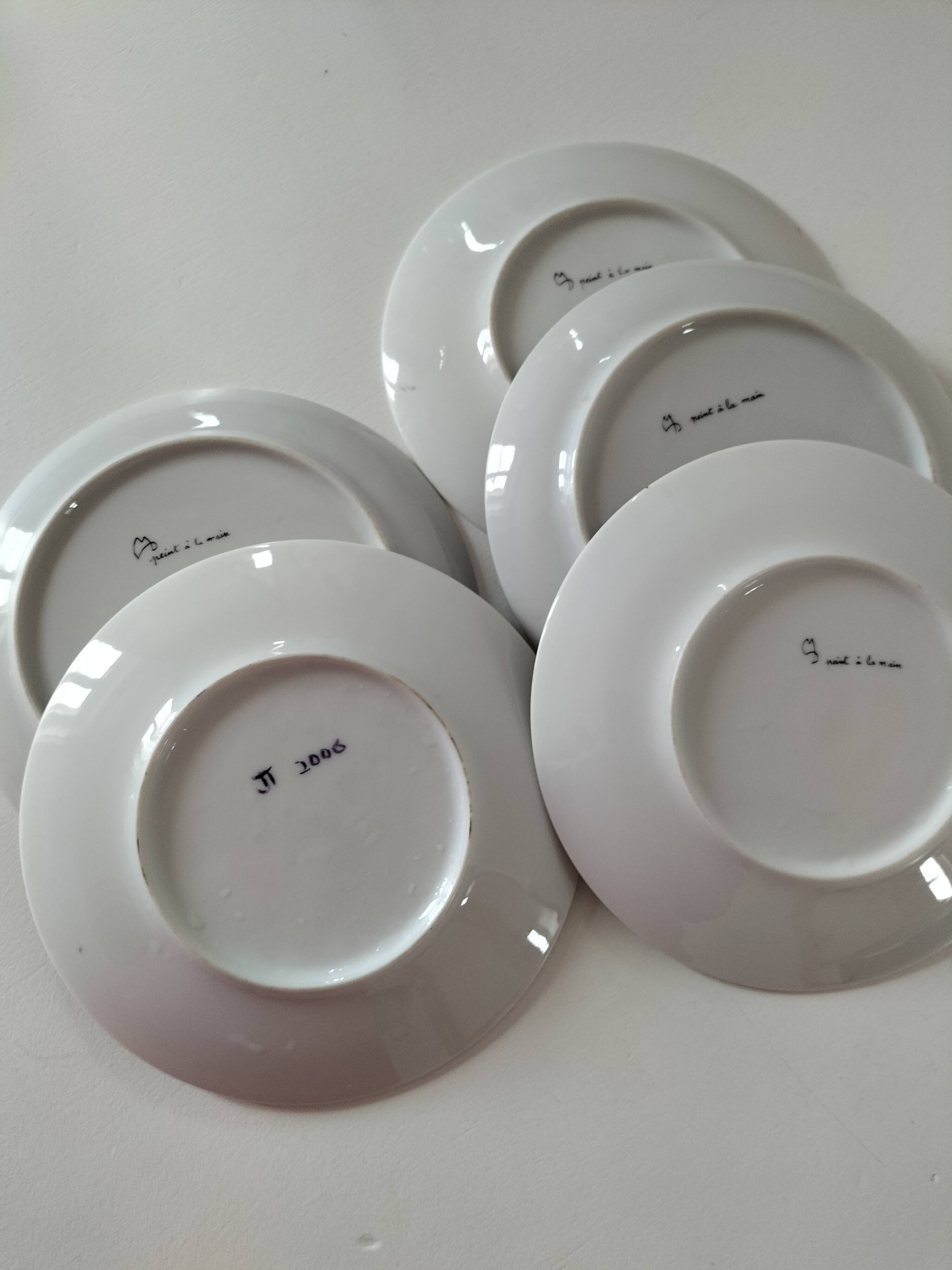 5 hand-painted dessert plates with stylised fruit designs.