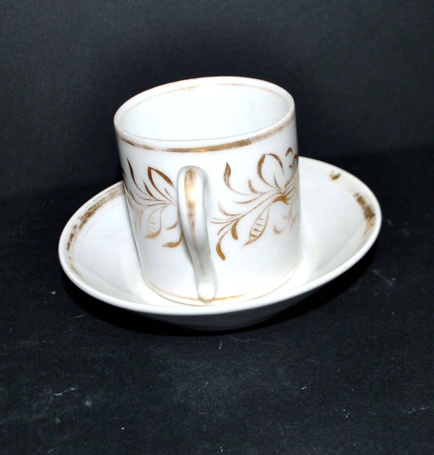 Paris porcelain coffee cup with floral design, antique porcelain with gold trim.