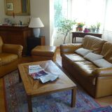 Tan leather sofa with natural graining, matching armchair and pouf
