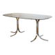 Dining table with smoked glass top and chrome base.
