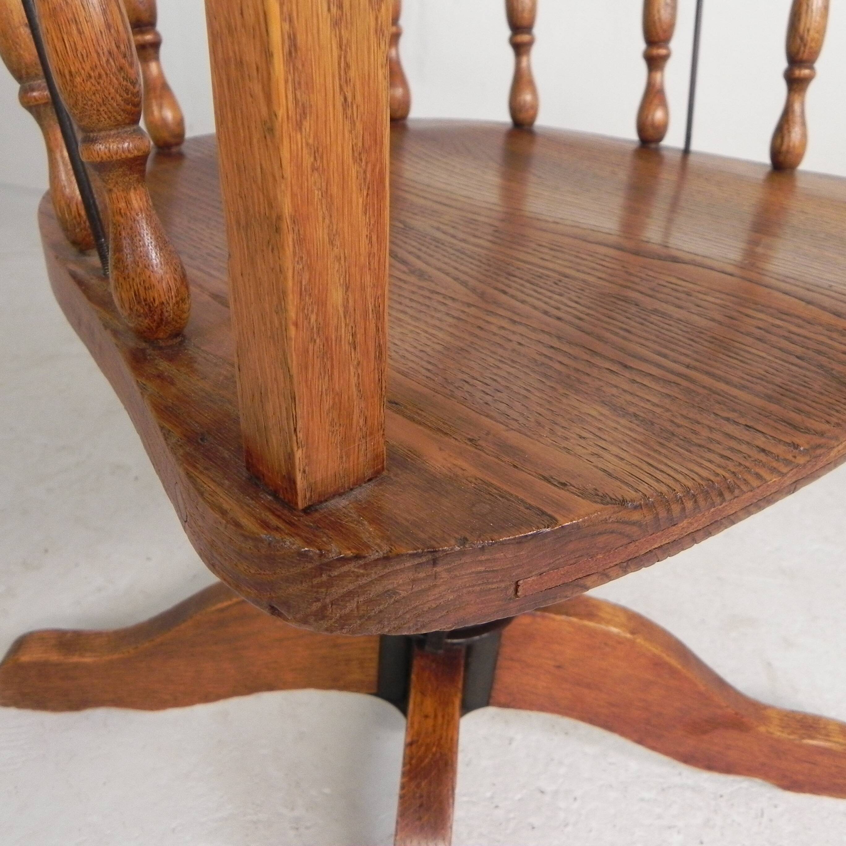 Oak office chair with a spring system and height adjustable, 1930s.