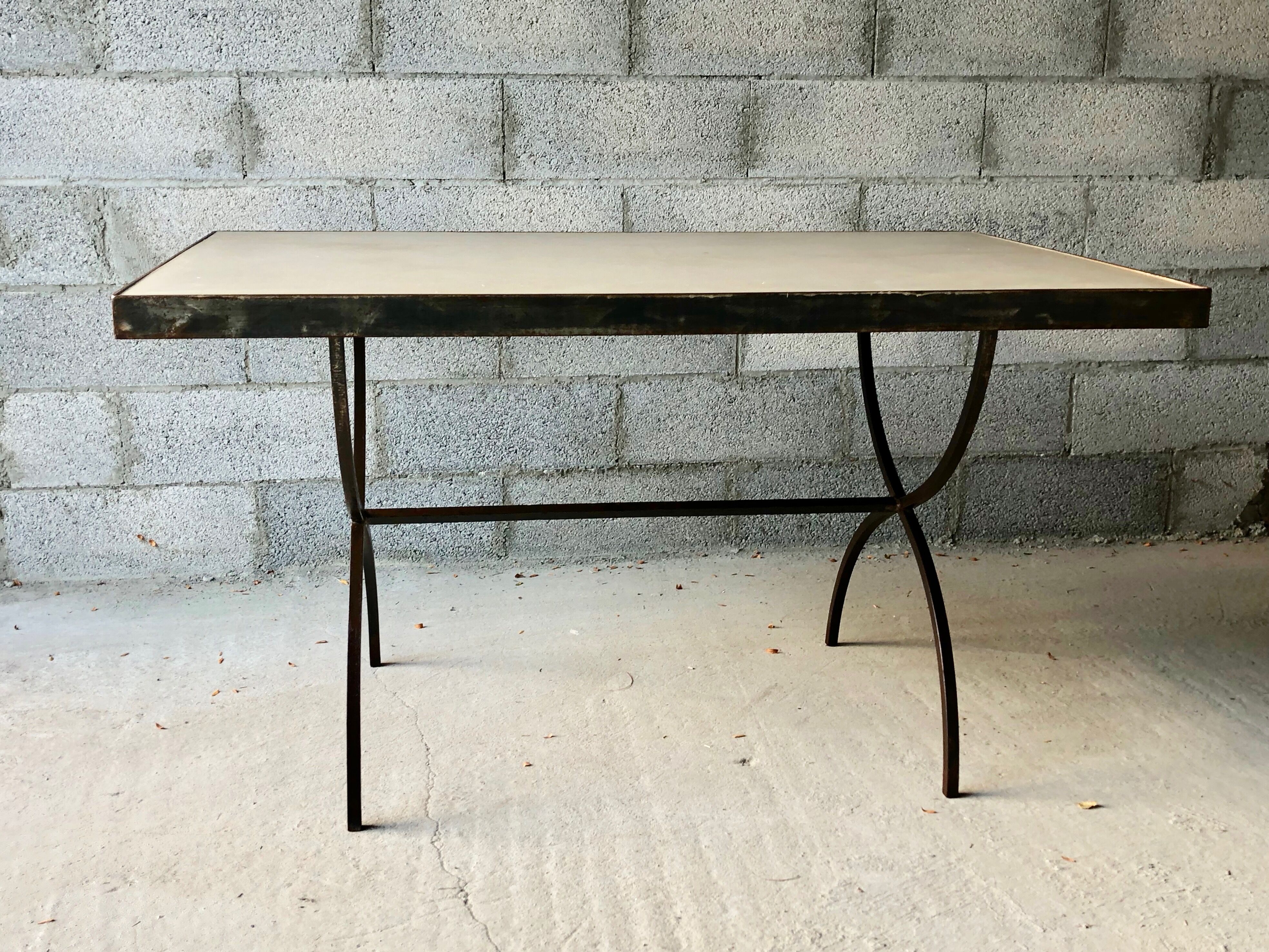 Table made of wrought iron and cement