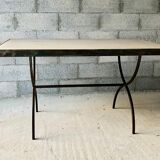 Table made of wrought iron and cement