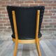 Cocktail armchair of the 50s in wood and black imitation