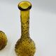 Set of two vintage textured amber glass Empoli bottles.