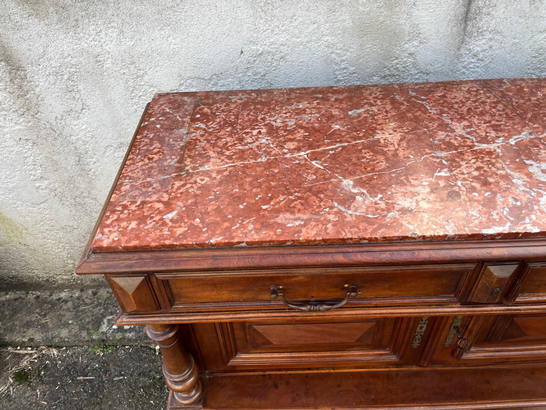 Henri II style console table with a red marble top.